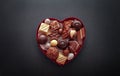 Chocolate pralines in heart shape box Royalty Free Stock Photo